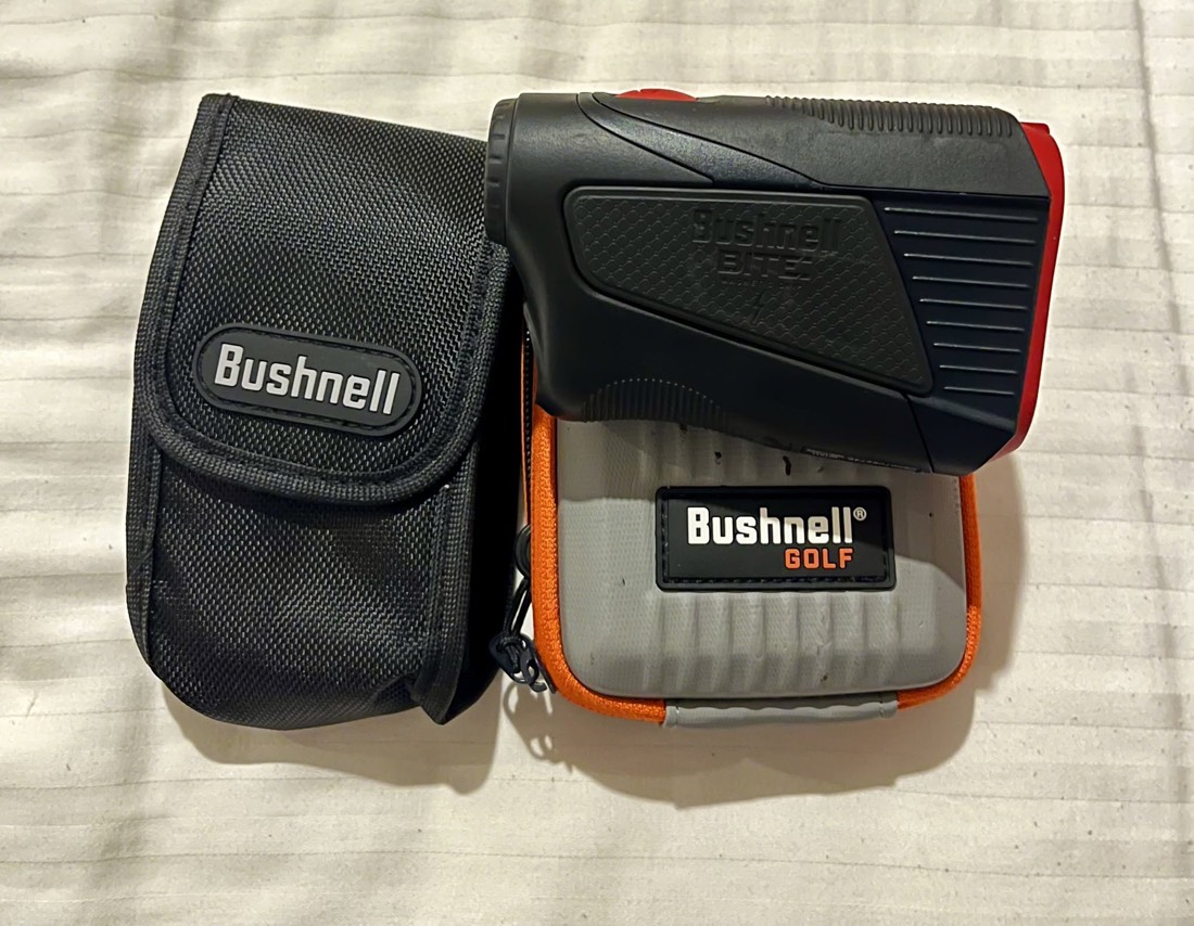 A Bushnell laser rangefinder with its case.
