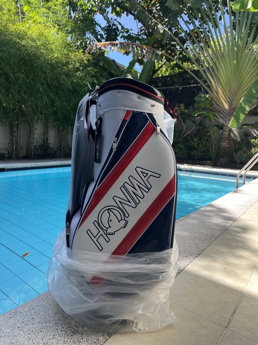 A Honma golf bag photographed in daylight.
